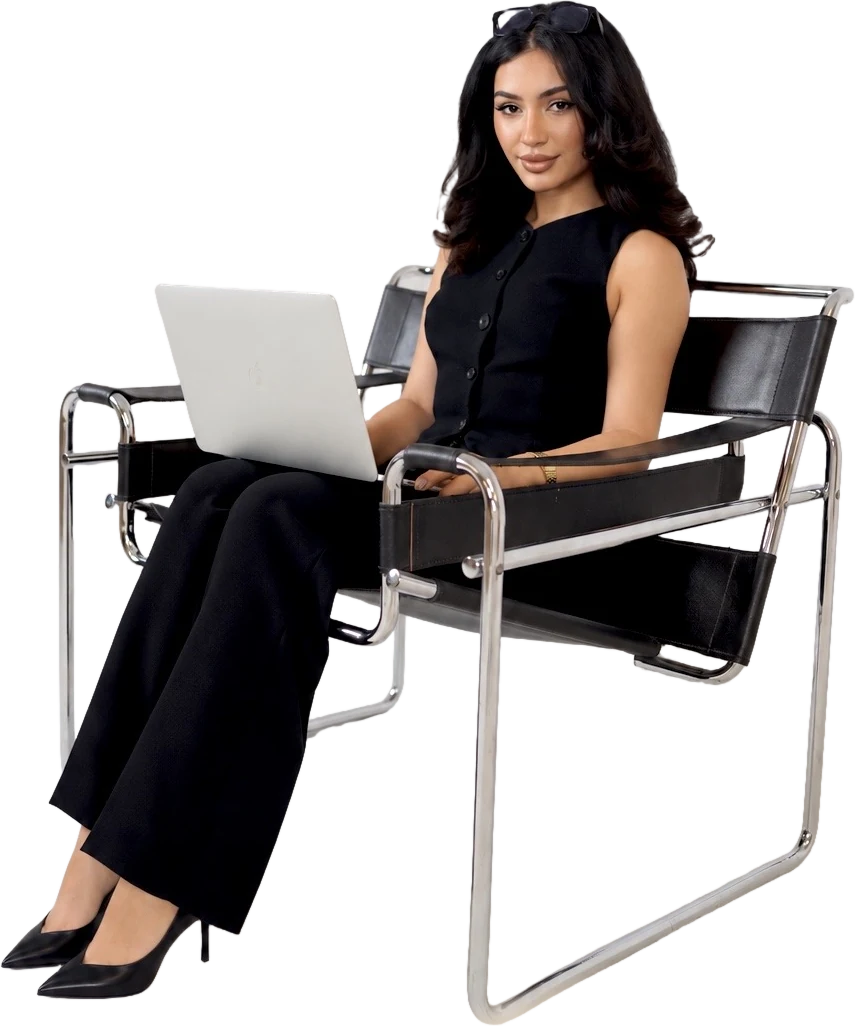 Helia Homam, founder of GrandAscend, seated with her laptop